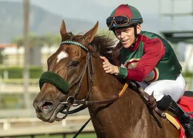 Grand Slam Smile pointing to Great Lady M.